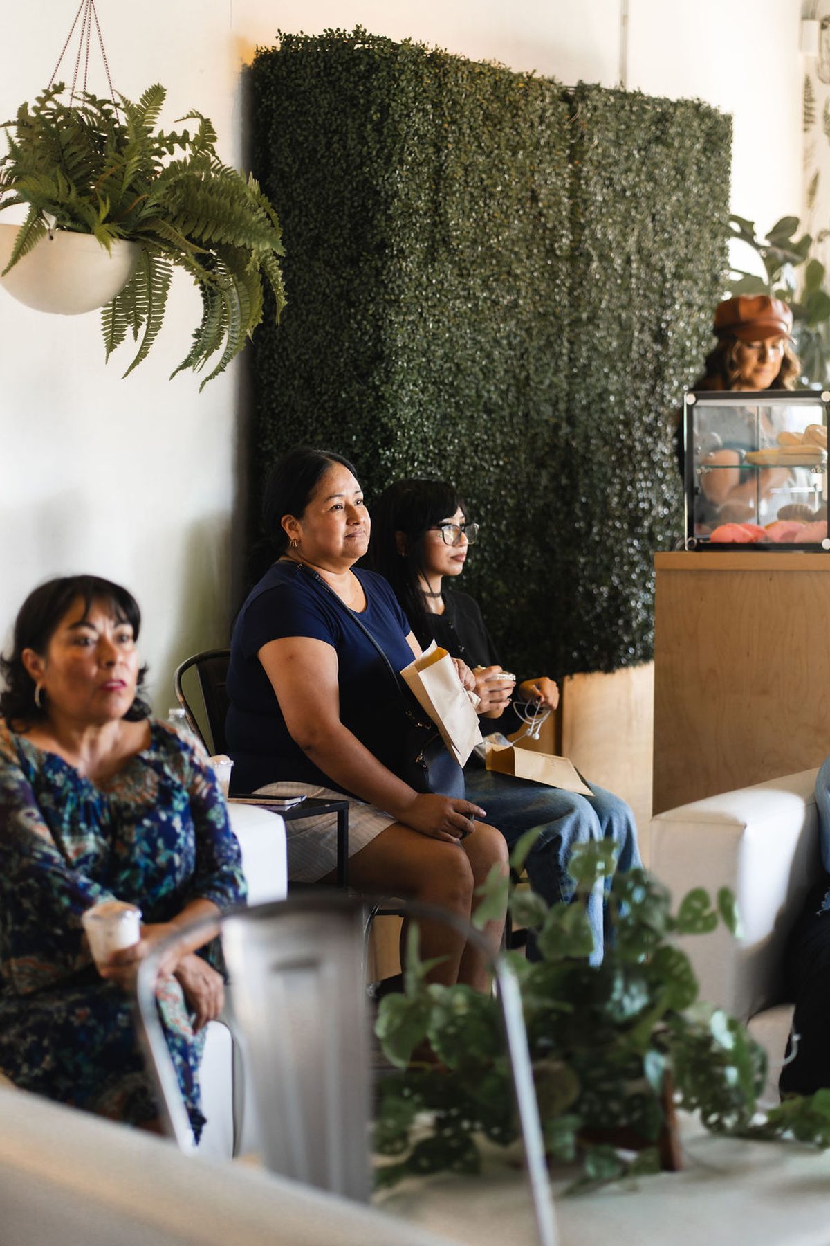 Guests seated by the fern wall