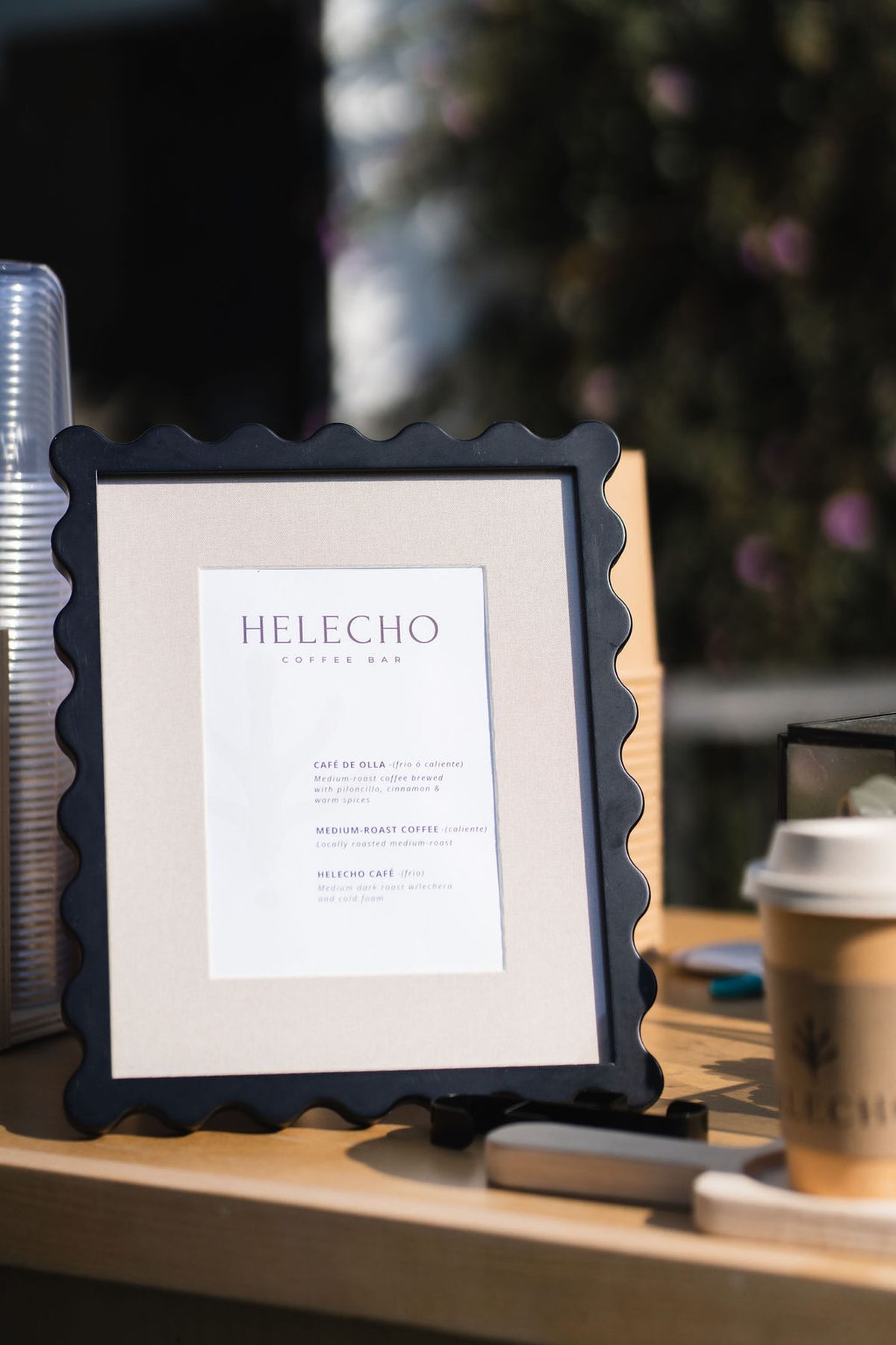 The Helecho menu in a scalloped black frame
